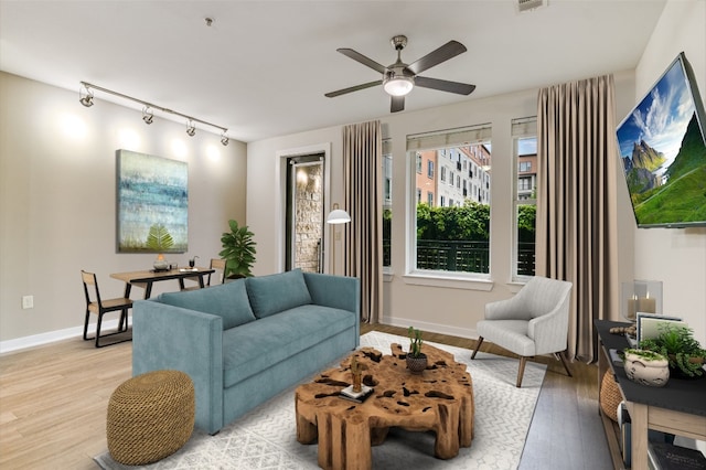 1900 Barton Springs Rd Unit 1009, Austin, TX 78704 - living area with light wood-style flooring, track lighting, and a ceiling fan