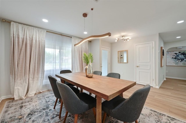 2607 Coatbridge Dr, Austin, TX 78745 - dining area with light wood-style flooring, recessed lighting, arched walkways, and a chandelier