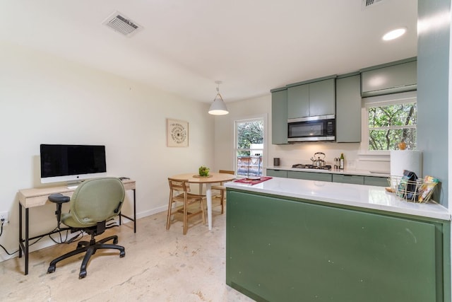 239 Brahan Blvd, San Antonio, TX 78215 - kitchen featuring stainless steel microwave, plenty of natural light, gas cooktop, and light countertops