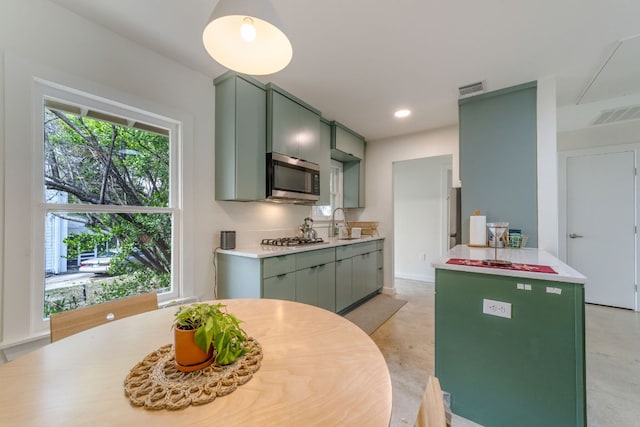 239 Brahan Blvd, San Antonio, TX 78215 - kitchen with stainless steel appliances, green cabinets, light countertops, a sink, and recessed lighting