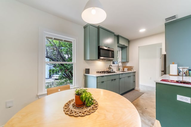 239 Brahan Blvd, San Antonio, TX 78215 - kitchen with appliances with stainless steel finishes, green cabinetry, light countertops, a sink, and recessed lighting