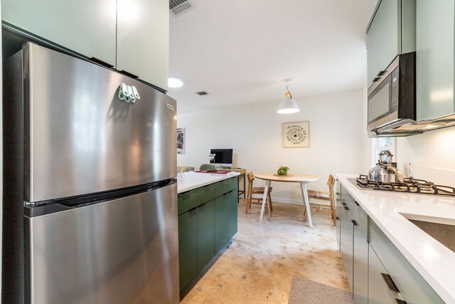 239 Brahan Blvd, San Antonio, TX 78215 - kitchen with appliances with stainless steel finishes, green cabinetry, light countertops, and concrete floors