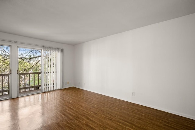 620 S 1st St Unit 209, Austin, TX 78704 - spare room featuring wood finished floors and baseboards