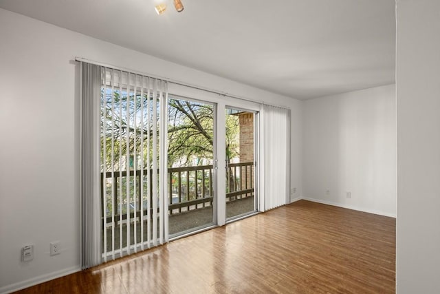 620 S 1st St Unit 209, Austin, TX 78704 - spare room featuring wood finished floors and baseboards