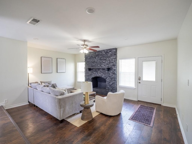 living room with a ceiling fan, wood finished floors, a wealth of natural light, and visible vents