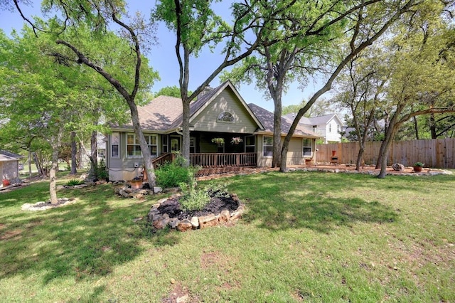 back of property featuring fence and a lawn