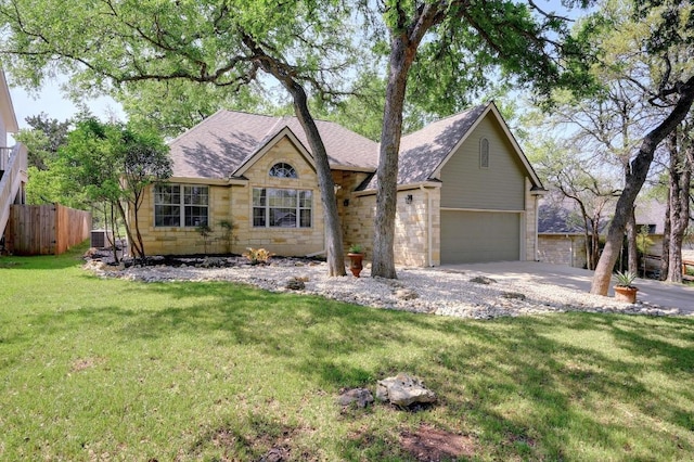 ranch-style house featuring stone siding, roof with shingles, central air condition unit, fence, and a front lawn