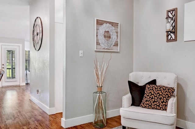 sitting room featuring baseboards and wood finished floors