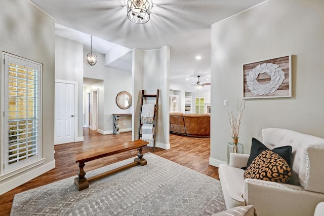 interior space featuring baseboards, wood finished floors, and a ceiling fan