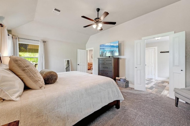 bedroom with lofted ceiling, carpet flooring, baseboards, ceiling fan, and visible vents