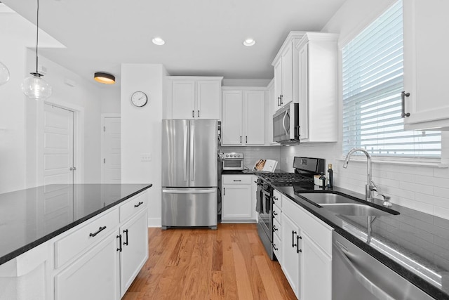 5911 Rubicon Run, Austin, TX 78745 - kitchen with stainless steel appliances, a sink, backsplash, white cabinets, and recessed lighting