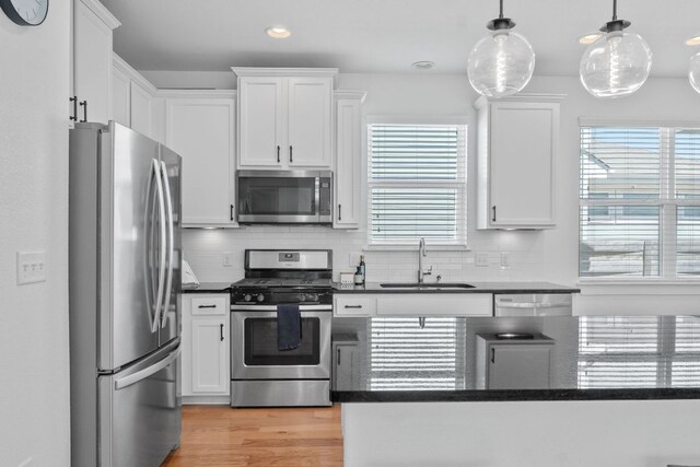5911 Rubicon Run, Austin, TX 78745 - kitchen with appliances with stainless steel finishes, a sink, tasteful backsplash, white cabinets, and recessed lighting
