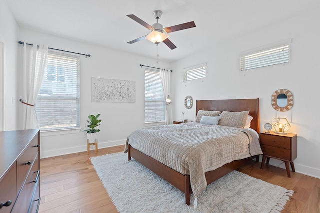 5911 Rubicon Run, Austin, TX 78745 - bedroom featuring multiple windows, light wood finished floors, and baseboards