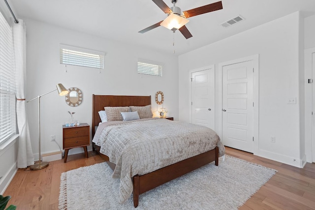 5911 Rubicon Run, Austin, TX 78745 - bedroom with light wood-style floors, multiple windows, and baseboards