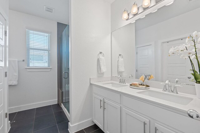 5911 Rubicon Run, Austin, TX 78745 - bathroom featuring double vanity, tile patterned floors, a stall shower, and baseboards