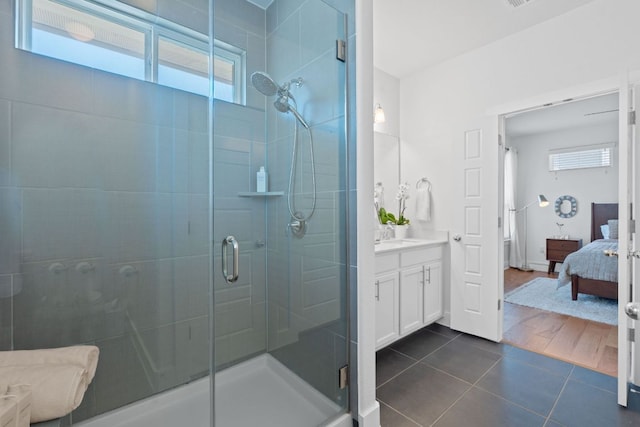 5911 Rubicon Run, Austin, TX 78745 - bathroom with connected bathroom, vanity, a stall shower, and tile patterned flooring