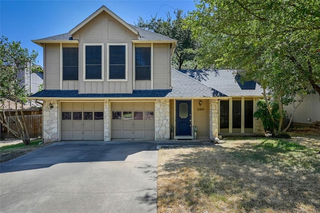 13109 New Boston Bnd, Austin, TX 78729 - view of front of property with concrete driveway, stone siding, an attached garage, a shingled roof, and board and batten siding