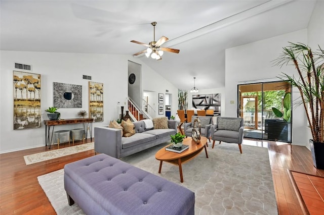 13109 New Boston Bnd, Austin, TX 78729 - living area featuring wood finished floors, stairs, ceiling fan, high vaulted ceiling, and baseboards