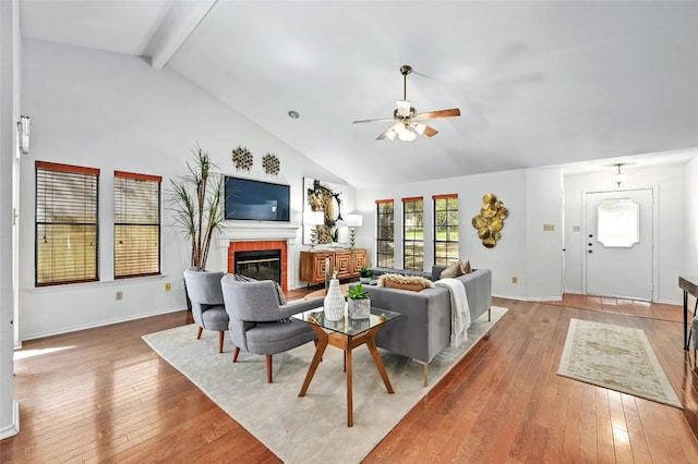 13109 New Boston Bnd, Austin, TX 78729 - living room with a ceiling fan, hardwood / wood-style floors, a brick fireplace, beam ceiling, and high vaulted ceiling