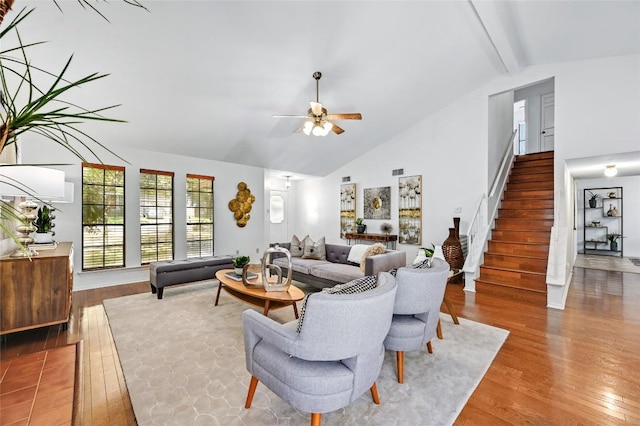 13109 New Boston Bnd, Austin, TX 78729 - living area with stairs, wood finished floors, a ceiling fan, high vaulted ceiling, and beam ceiling