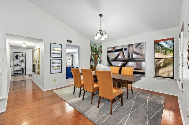 13109 New Boston Bnd, Austin, TX 78729 - dining room with a chandelier, hardwood / wood-style floors, baseboards, and high vaulted ceiling