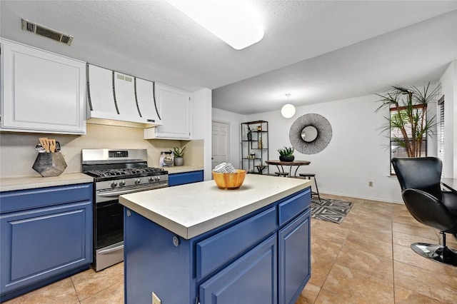 13109 New Boston Bnd, Austin, TX 78729 - kitchen with blue cabinets, gas range, light countertops, white cabinets, and a center island