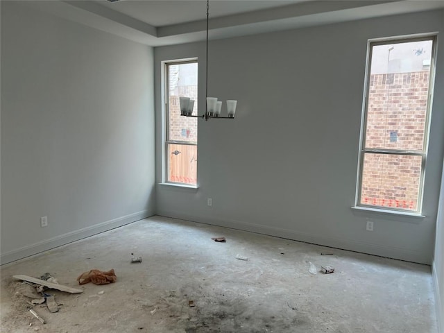 909 Landing Ln, Leander, TX 78641 - empty room featuring a chandelier and a tray ceiling