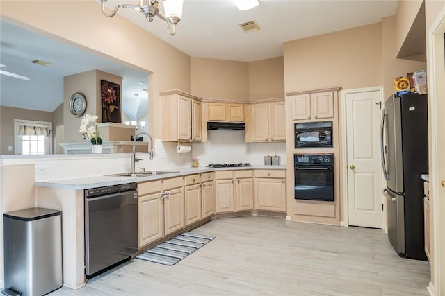 9120 Fainwood Ln, Austin, TX 78749 - kitchen with black appliances, decorative backsplash, light wood-style floors, and light brown cabinets
