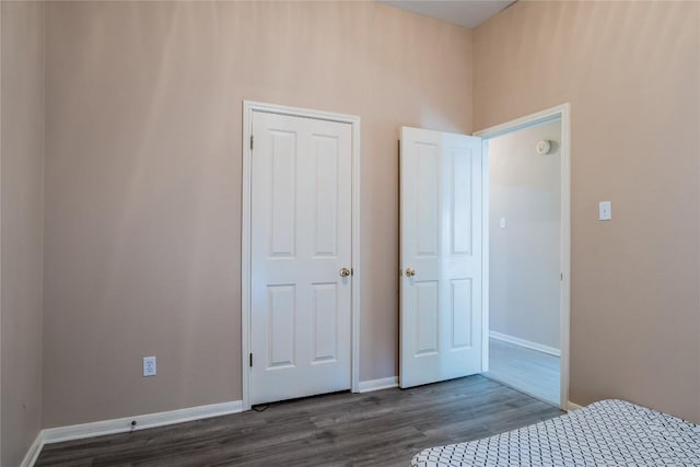 9120 Fainwood Ln, Austin, TX 78749 - unfurnished bedroom with dark wood finished floors and baseboards