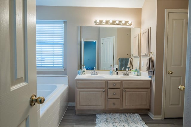 9120 Fainwood Ln, Austin, TX 78749 - full bath with a garden tub, double vanity, and wood finished floors