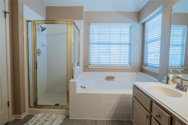 9120 Fainwood Ln, Austin, TX 78749 - full bath featuring a shower stall, a bath, vanity, and wood finished floors
