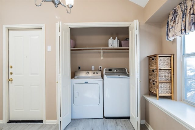 9120 Fainwood Ln, Austin, TX 78749 - washroom with independent washer and dryer and light wood-type flooring