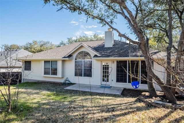 9120 Fainwood Ln, Austin, TX 78749 - rear view of property with a patio area, a chimney, a lawn, and roof with shingles