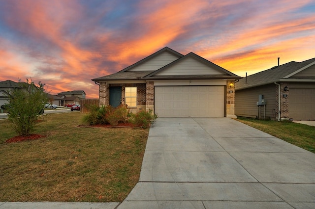 view of front of house with a front lawn, driveway, an attached garage, and brick siding