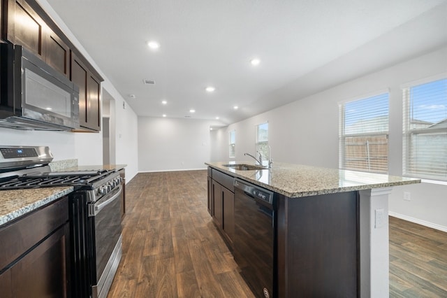 kitchen with dark wood-style flooring, a sink, dark brown cabinetry, and black appliances