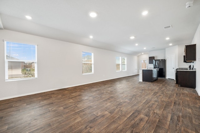 unfurnished living room with visible vents, baseboards, recessed lighting, and dark wood finished floors
