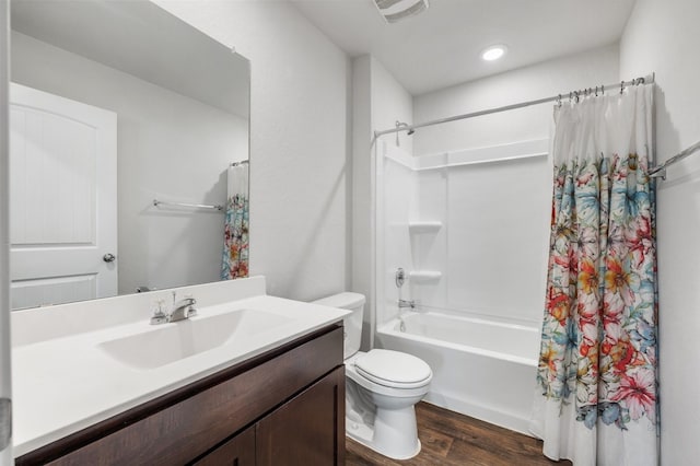 full bathroom featuring visible vents, wood finished floors, toilet, vanity, and shower / bath combination with curtain