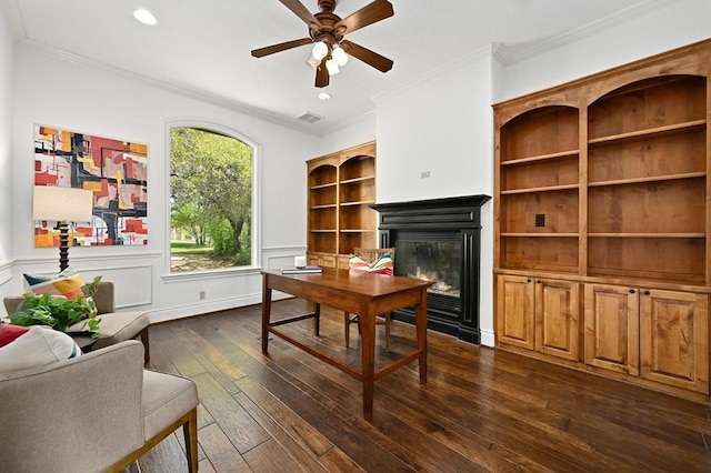 3416 Tarlton Ln, Austin, TX 78746 - home office featuring dark wood-style flooring, a glass covered fireplace, ceiling fan, crown molding, and wainscoting
