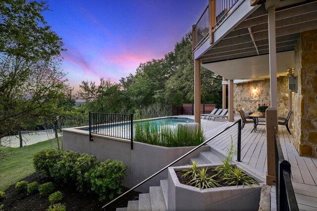 3416 Tarlton Ln, Austin, TX 78746 - pool at dusk featuring an outdoor pool and a deck