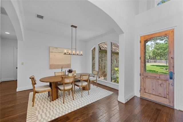 3416 Tarlton Ln, Austin, TX 78746 - dining space featuring plenty of natural light, dark wood-type flooring, arched walkways, baseboards, and recessed lighting