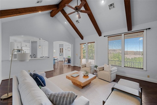 3416 Tarlton Ln, Austin, TX 78746 - living area with arched walkways, wood finished floors, beamed ceiling, baseboards, and ceiling fan