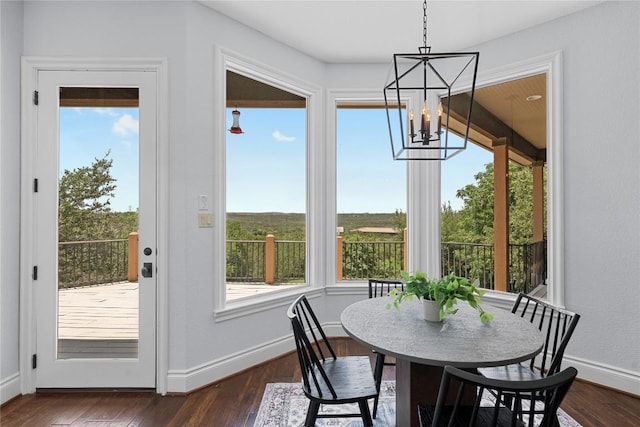 3416 Tarlton Ln, Austin, TX 78746 - dining room with a chandelier, healthy amount of natural light, dark wood finished floors, and baseboards