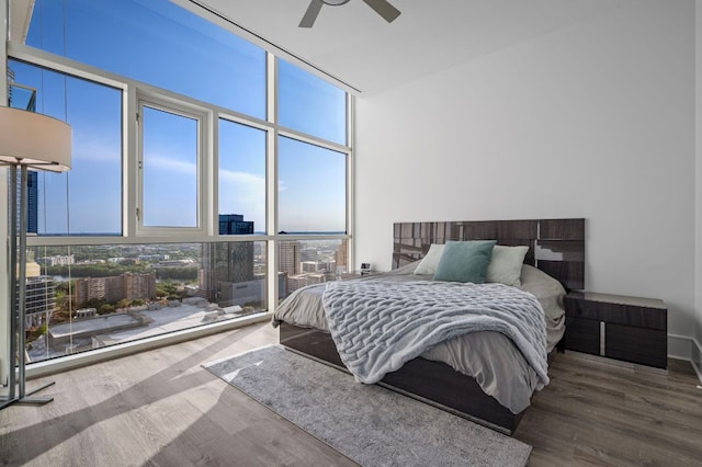 555 E 5th St Unit 2906, Austin, TX 78701 - bedroom with floor to ceiling windows, wood finished floors, a view of city, and ceiling fan