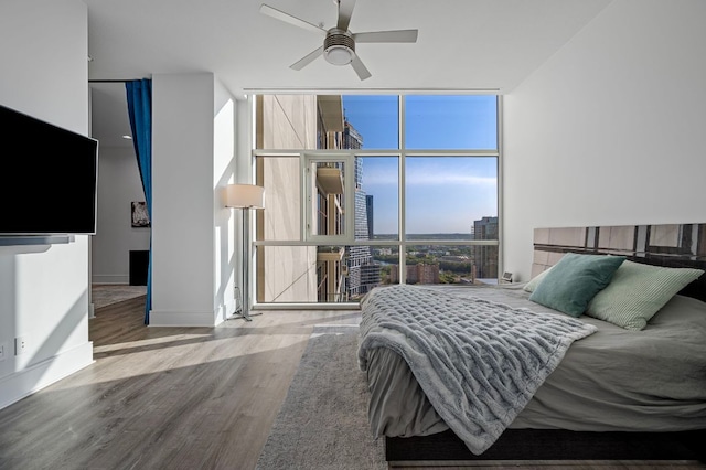 555 E 5th St Unit 2906, Austin, TX 78701 - bedroom featuring a wall of windows, wood finished floors, and ceiling fan