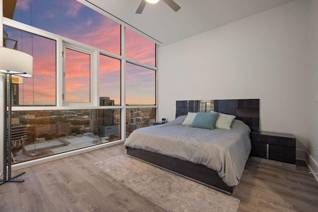 555 E 5th St Unit 2906, Austin, TX 78701 - bedroom featuring floor to ceiling windows, wood finished floors, and a ceiling fan