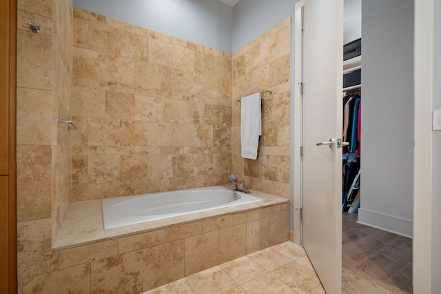 555 E 5th St Unit 2906, Austin, TX 78701 - full bathroom with a relaxing tiled tub, a tile shower, and a walk in closet