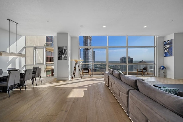 555 E 5th St Unit 2906, Austin, TX 78701 - living room with wood finished floors, expansive windows, a city view, and recessed lighting