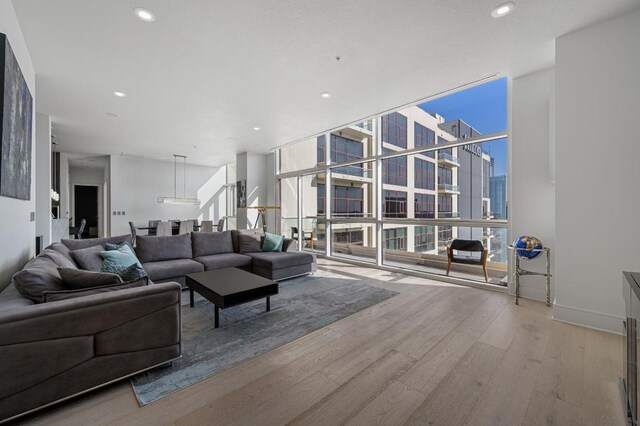 555 E 5th St Unit 2906, Austin, TX 78701 - living area with floor to ceiling windows, wood finished floors, recessed lighting, and a city view