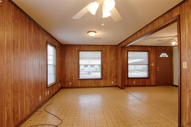 1116-C Simpson St, Schulenburg, TX 78956 - empty room with a ceiling fan, baseboards, wooden walls, and visible vents