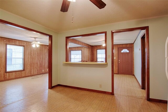 1116-C Simpson St, Schulenburg, TX 78956 - spare room featuring baseboards, wooden walls, a ceiling fan, and light floors